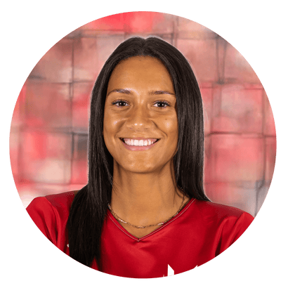 Harper Murray smiling in a red volleyball jersey