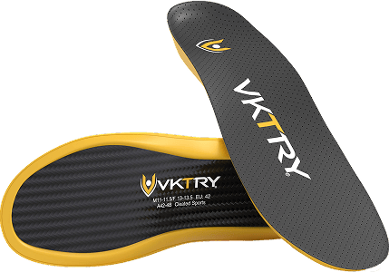 Angled view of VKTRY Gold insoles showing carbon-fiber top, gold foam edge and size markings on transparent background